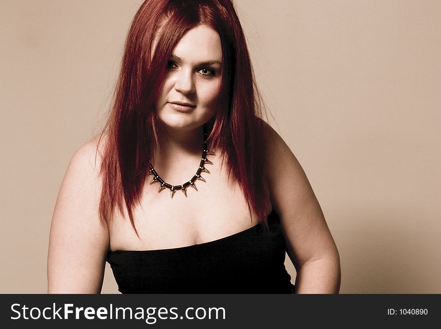 Red hair female model in suggestive position and goth look. Red hair female model in suggestive position and goth look