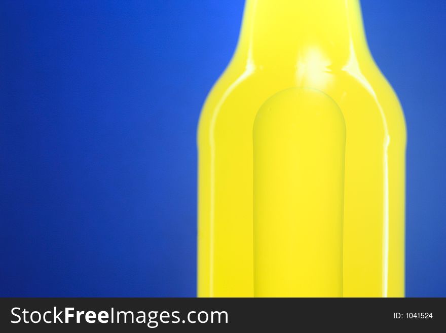 Glowing bottle of yellow drink on blue gradient background with bubble of air inside. Glowing bottle of yellow drink on blue gradient background with bubble of air inside