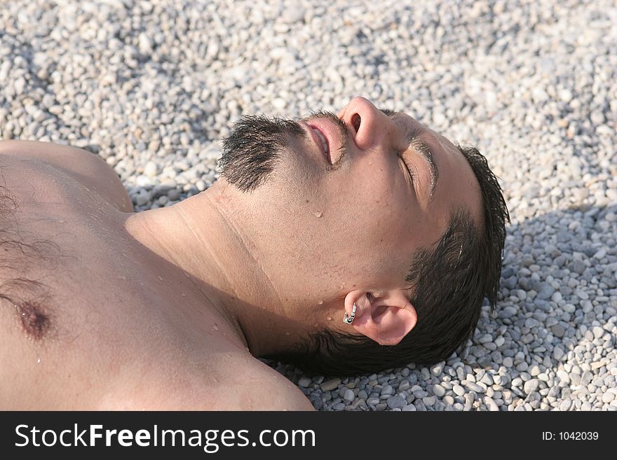 Young man sleping on the beach. Young man sleping on the beach