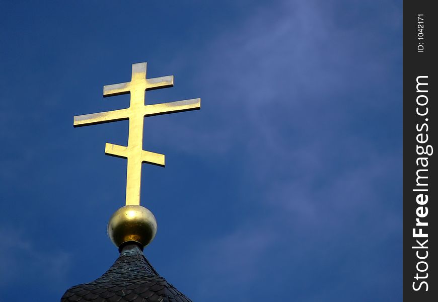 Golden Orthodox Cross On Blue Sky