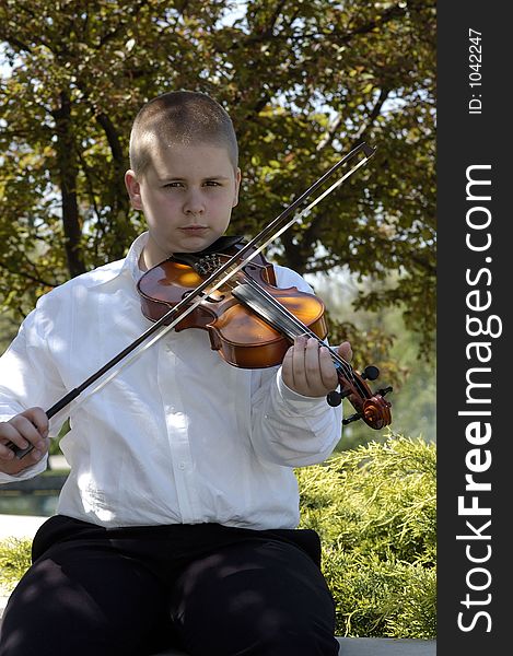 Boy Sitting Outside Playing Viola