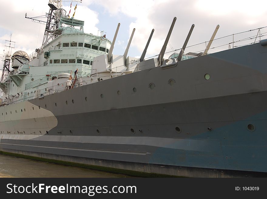 HMS Belfast Battleship from the side with guns pointing up. HMS Belfast Battleship from the side with guns pointing up.