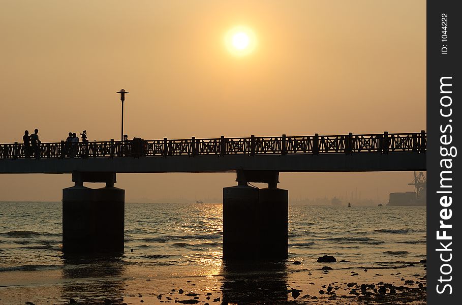 A bridge at the beach during sunset. A bridge at the beach during sunset