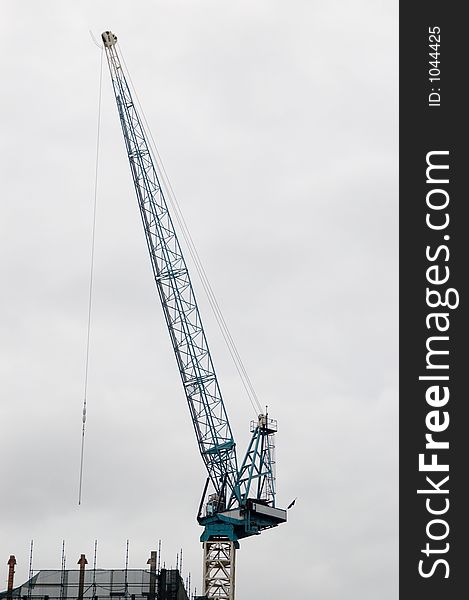 A large construction crane atop a building.