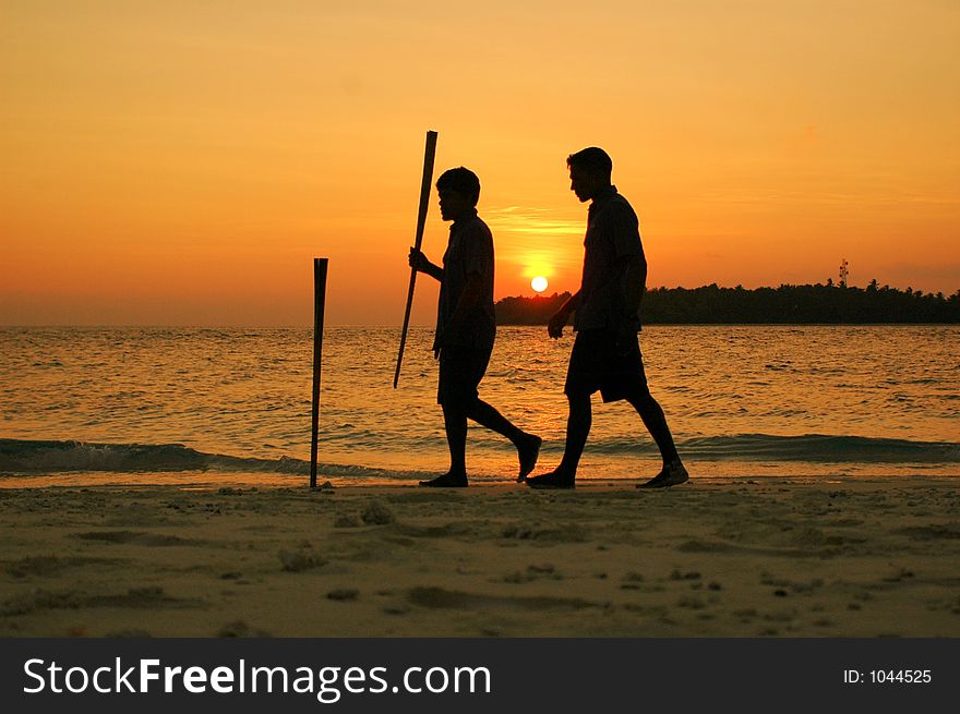 Two boys walking on a sunset. Two boys walking on a sunset