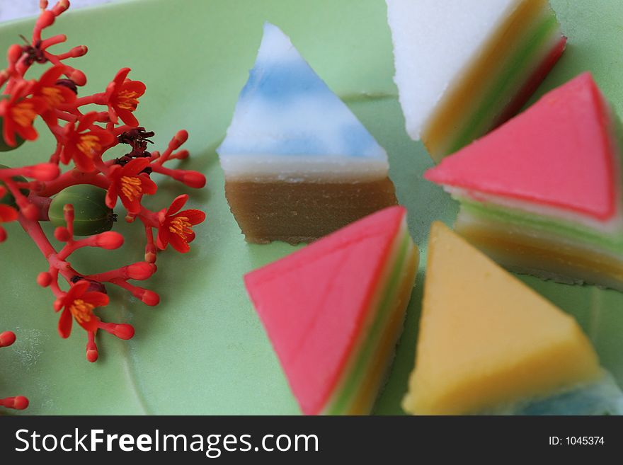 Sweet and colorful layer cakes displayed in green plate. Sweet and colorful layer cakes displayed in green plate