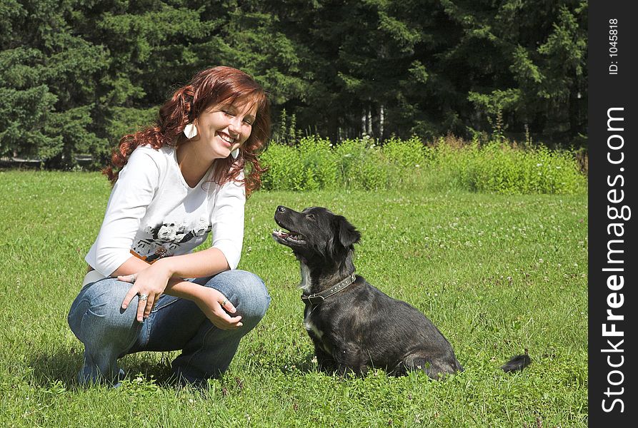 Beautiful girl wiht dog in summer day