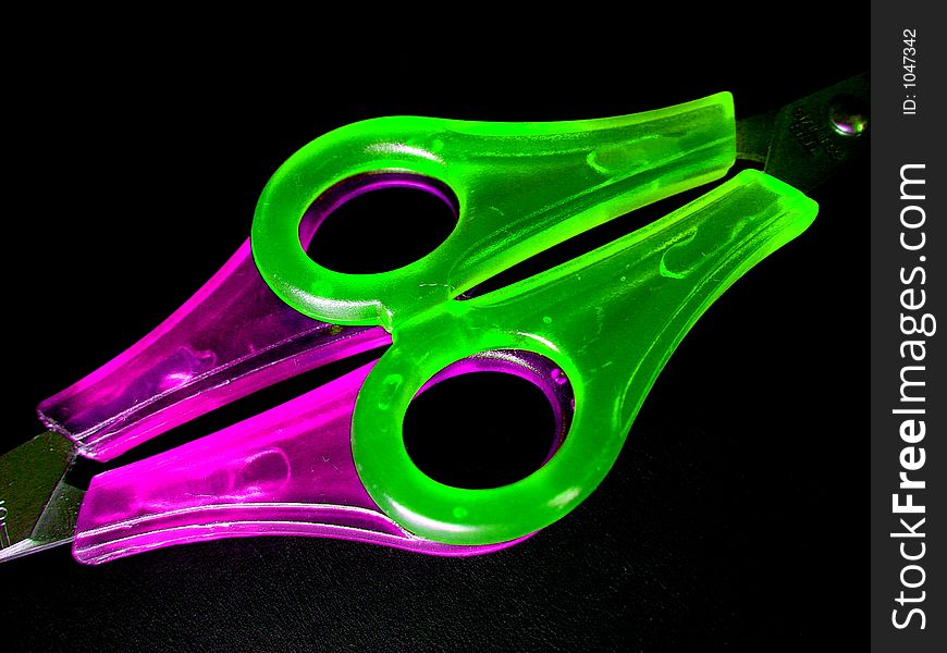 Two colorful scissors on black. Two colorful scissors on black