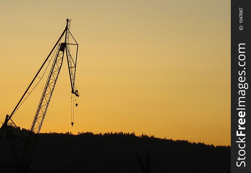 Silhouette of a crane with sunset sky. Silhouette of a crane with sunset sky