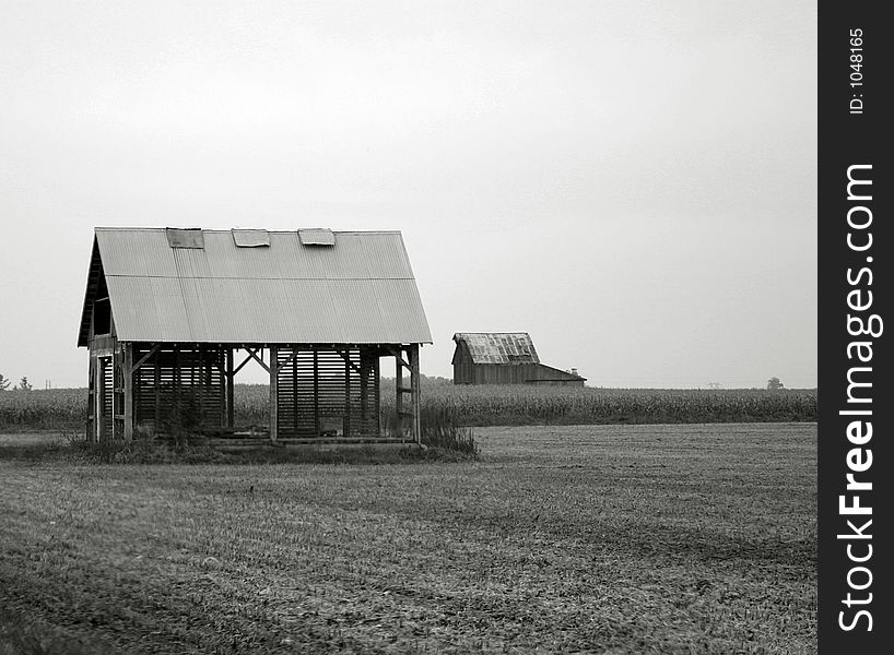 Black and white image of a dilapidated farm building. Black and white image of a dilapidated farm building