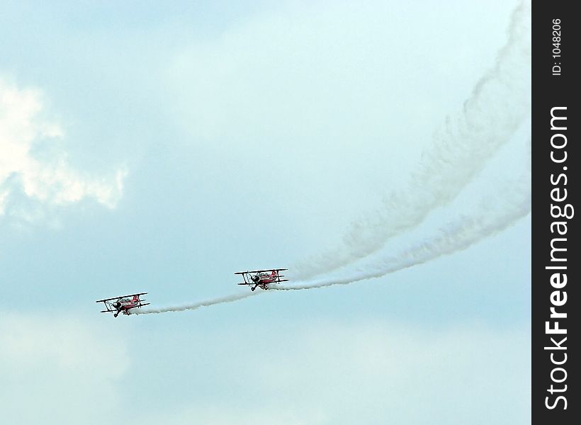 Stunt planes performing at an airshow.