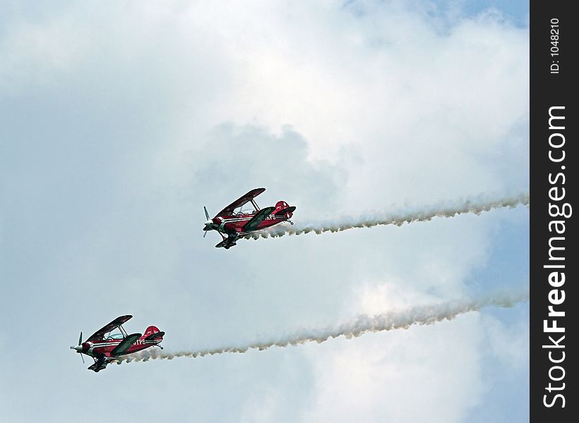 Stunt planes performing at an airshow.