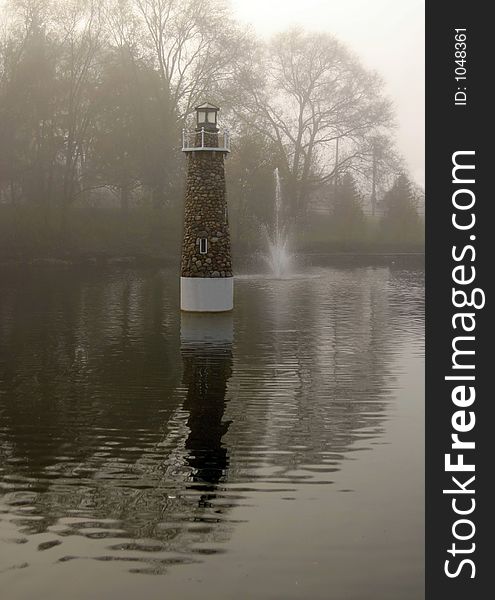 Sepia print of lighthouse in lake on foggy morning. Sepia print of lighthouse in lake on foggy morning.