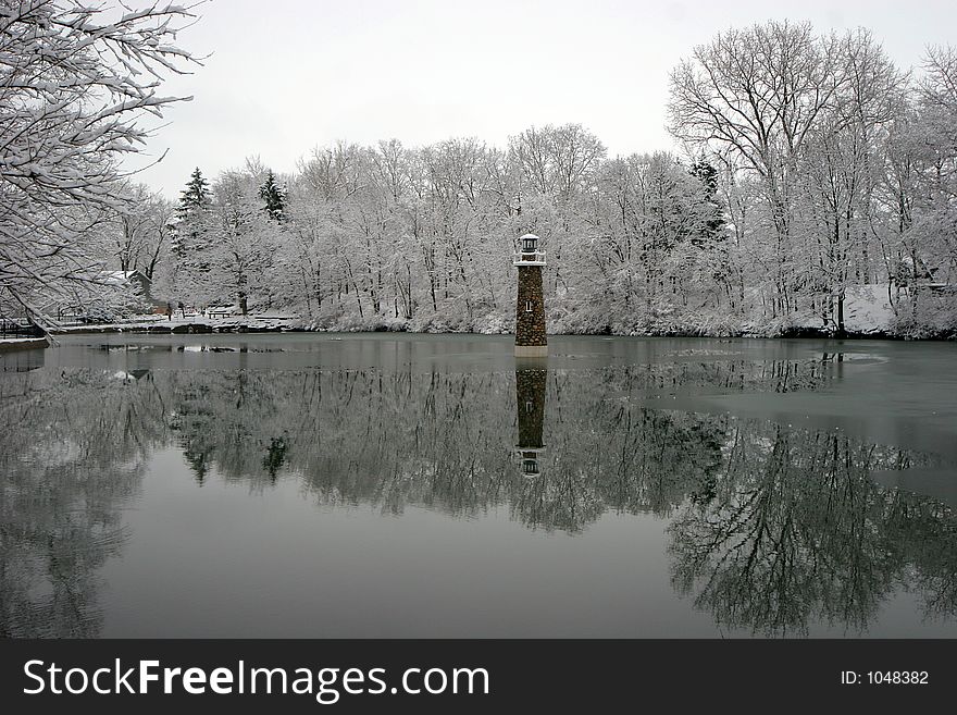 Lighthouse on calm winter pond. Lighthouse on calm winter pond.