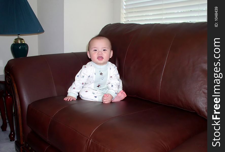 A baby on a sofa
