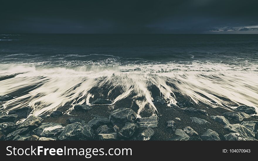 Dramatic Ocean Waves Crashing on Rocky Beach