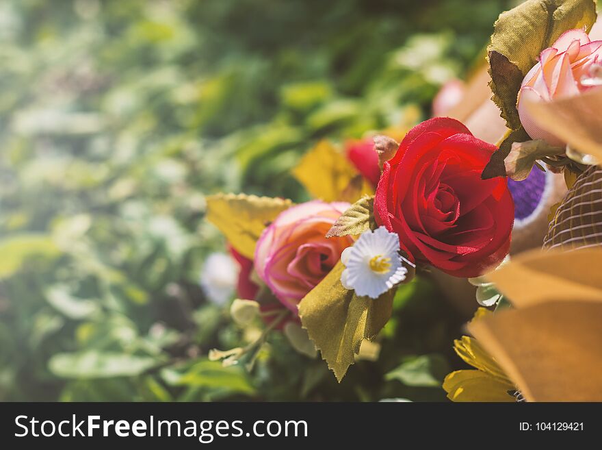 Bouquet of artificial roses in the park.