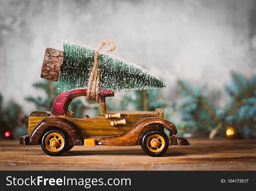 Vintage toy wooden machine carries a Christmas tree. Vintage toy wooden machine carries a Christmas tree