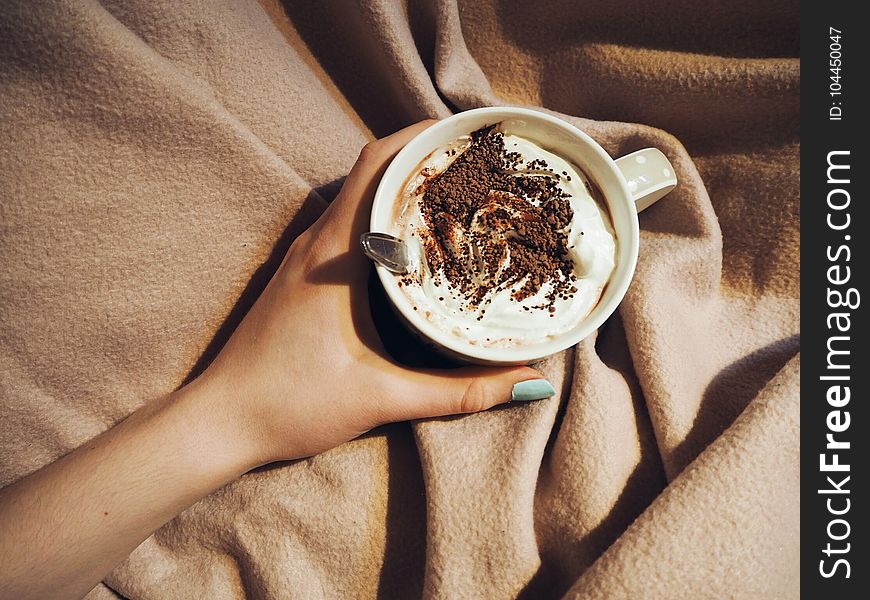 Person Holding Cup With Coffee Latte With Spoon Inside