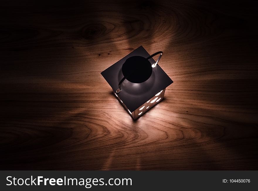 Gray Steel Candle Lantern on Brown Wooden Board