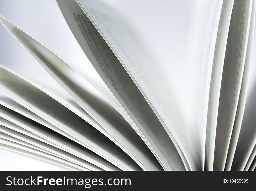 Closeup of book pages on a white background
