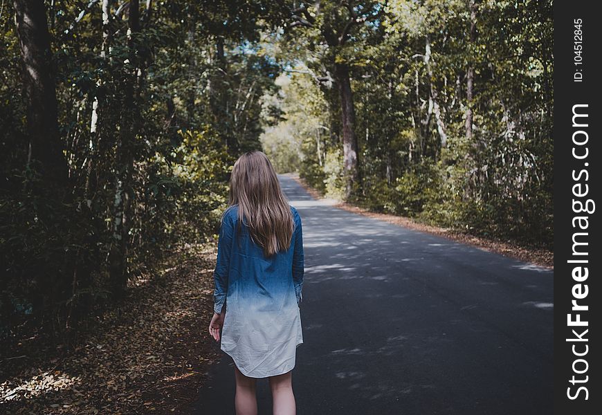 Woman Wearing Blue And White Long-sleeved Shirt Walking Near Tree