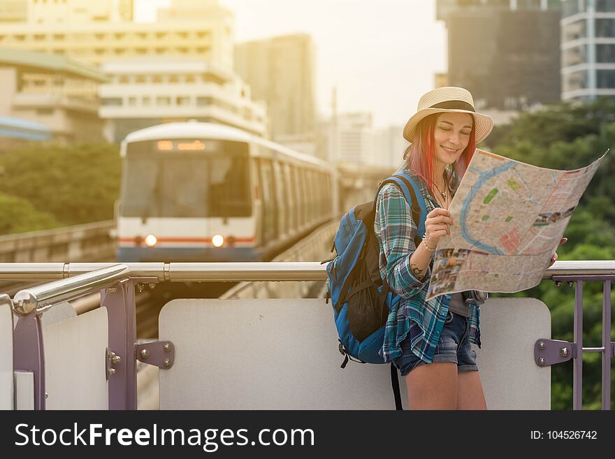 Woman westerner looking at map during city tour in the morning, planning for today`s trip