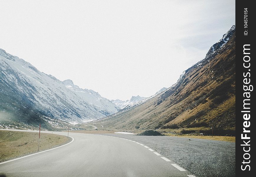 Gray Concrete Road Surrounded With Mountains