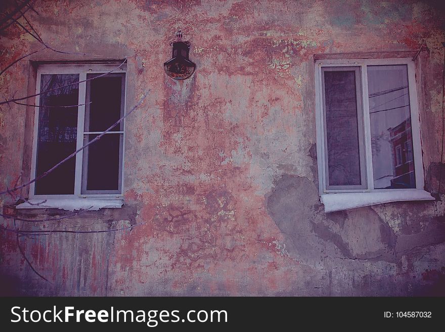 Old walls with cracked plaster and two windows. Old walls with cracked plaster and two windows.