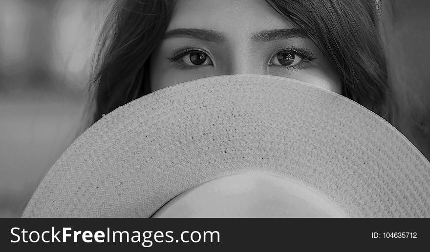Grayscale Photography Of Woman Covering Her Face With Sun Hat