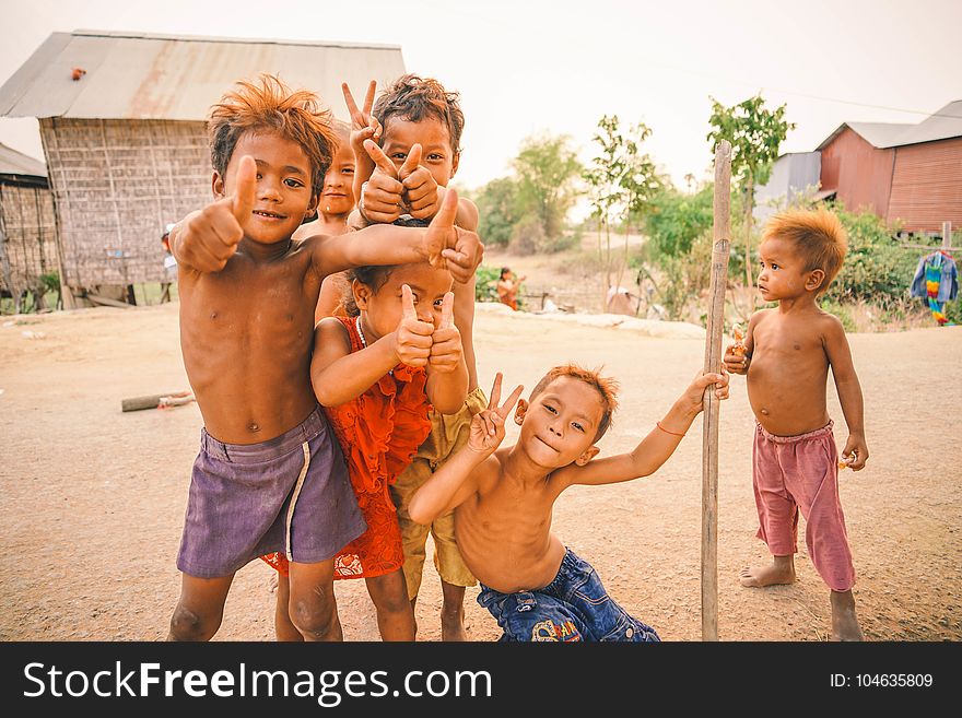 Six Boys Standing Near Trees And Houses Photo Taken