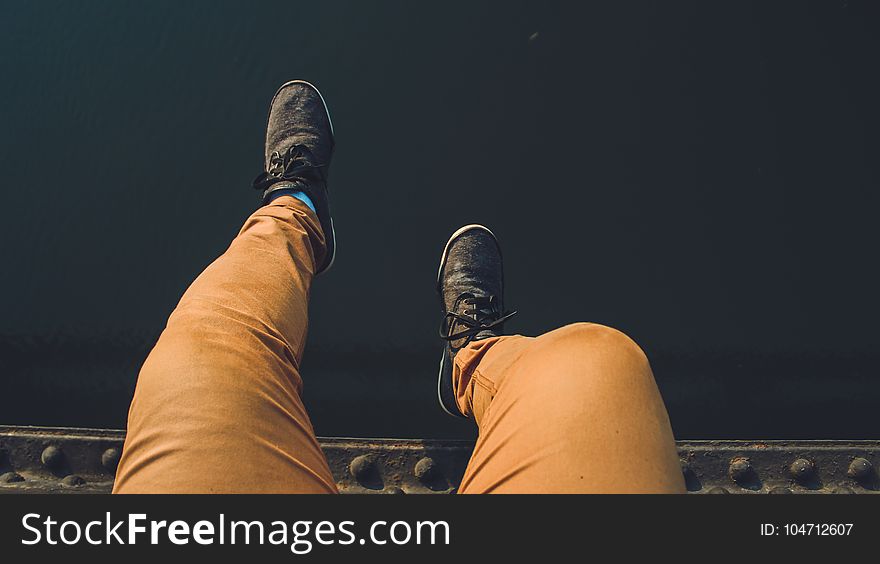 Person Wearing Brown Jeans With Pair of Black Sneakers