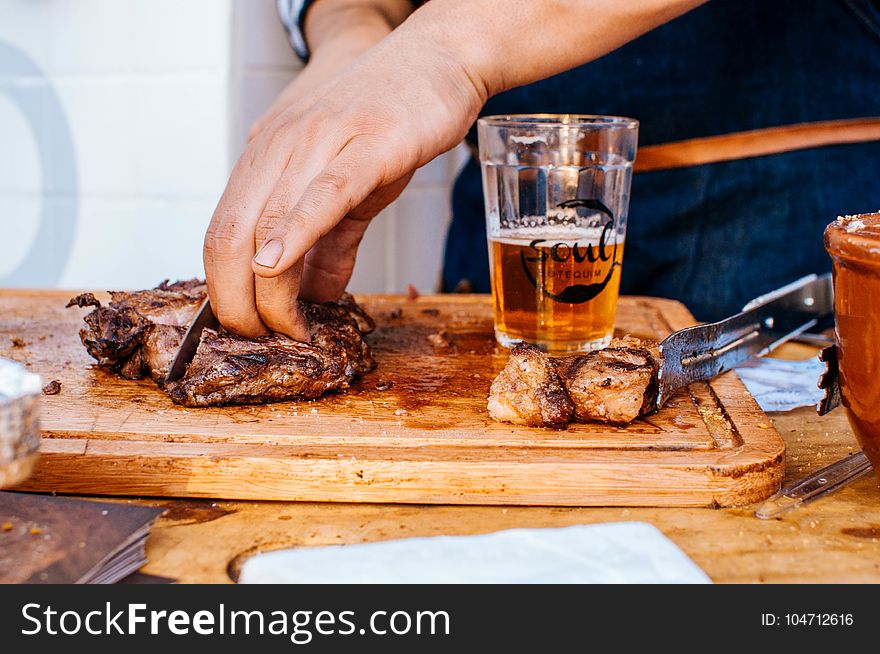Person Slicing Grilled Meat