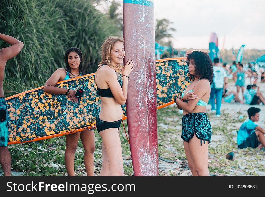 Women Wearing Black While Holding Surf Boards