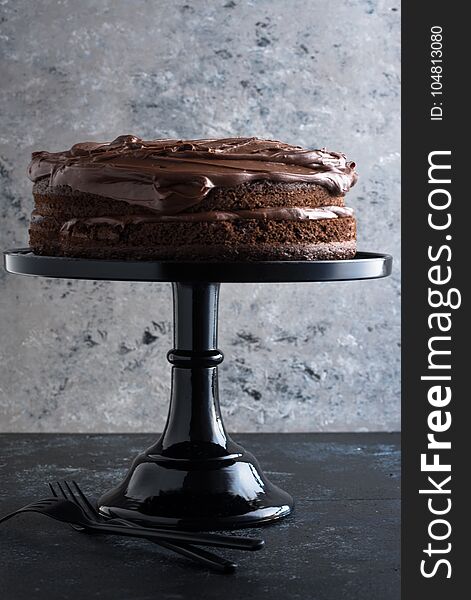 Round Chocolate layer cake presented on a dessert. Round Chocolate layer cake presented on a dessert