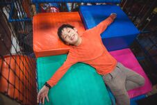 Boy Lying On Colorful Floor At Indoor Playground Royalty Free Stock Image