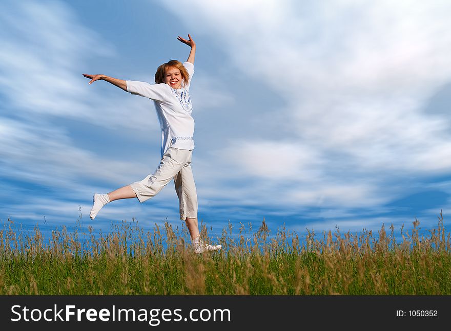 Jumping Girl Under Clouds