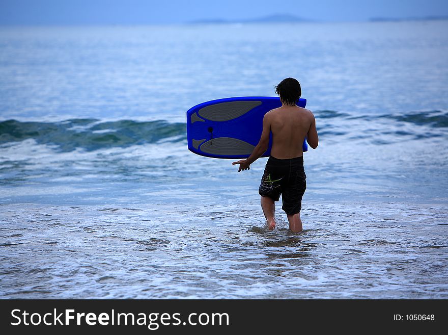 Young man going to surf. Young man going to surf