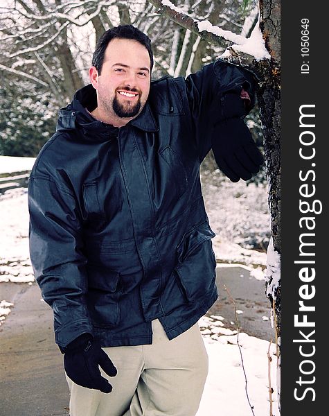 Handsome male posing outdoors in the snow. Handsome male posing outdoors in the snow.