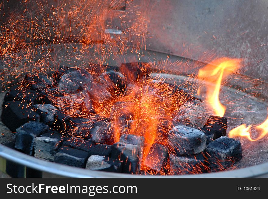 Fire sparkles on the barbecue