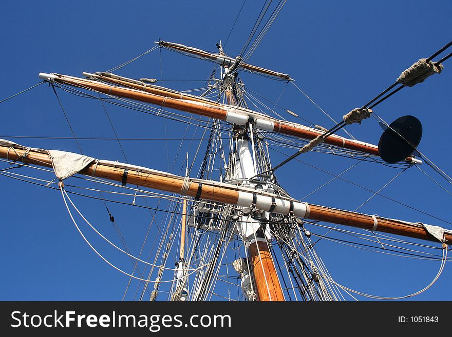 Looking directly up mast on a tall ship. Strong sense of depth and perspective. Semi-abstract background. Looking directly up mast on a tall ship. Strong sense of depth and perspective. Semi-abstract background.