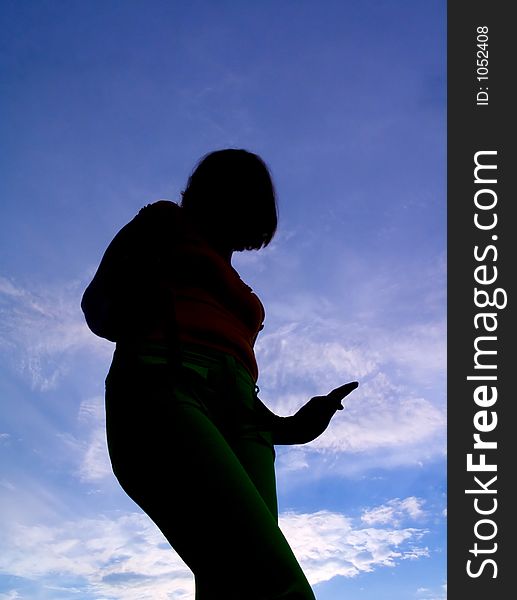 Feminine Silhouette On Background Sky