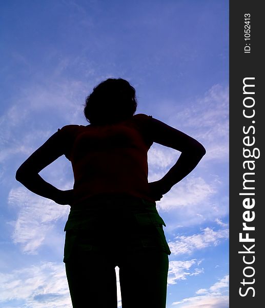 Feminine silhouette on background sky