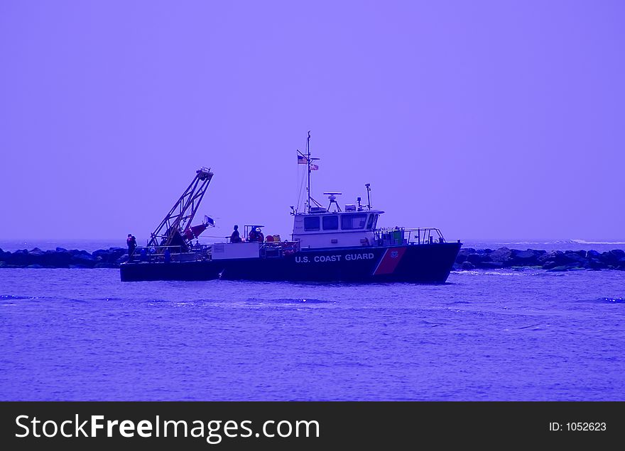 United States Coast Guard dropping channel buoys at sea. United States Coast Guard dropping channel buoys at sea.