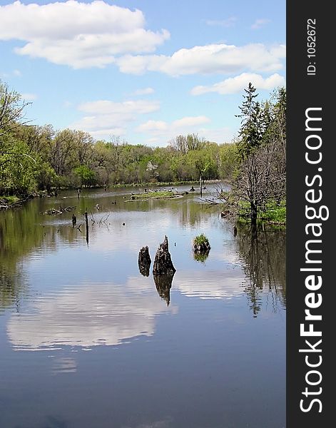 Creek in spring, reflection of sky and clouds in water. Creek in spring, reflection of sky and clouds in water