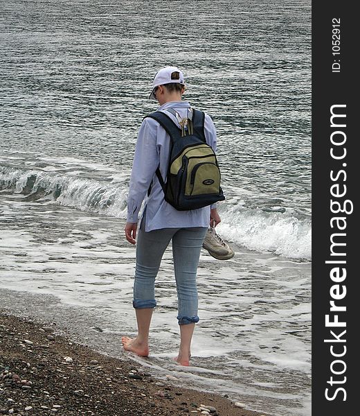 Girl walking alone on a beach