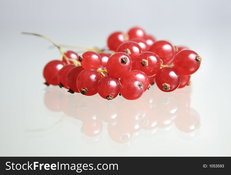 Red currants on a glass table