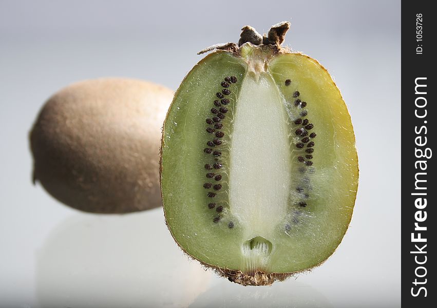 Kiwis on a glass table. Kiwis on a glass table