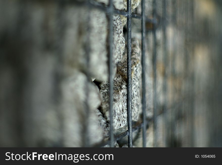 Stones imprisoned in a steelcage; shallow DOF. Stones imprisoned in a steelcage; shallow DOF