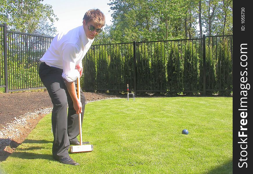 Jonny playing a casual game of back yard croquet...showing off for the camera,. Jonny playing a casual game of back yard croquet...showing off for the camera,